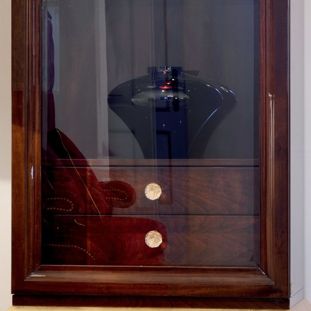 Brown Display Cabinet with Glass Shelves and Gold Accents